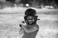 Little child baseball player focused ready to bat. Sporty kid players in helmet and baseball bat in action. Royalty Free Stock Photo