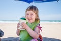 Little child with beverage container in hands at beach Royalty Free Stock Photo