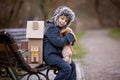 Little child, blond boy with pet dog, carying home on his back, kid, having paper house