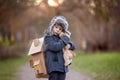 Little child, blond boy with pet dog, carying home on his back, kid, having paper house