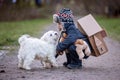 Little child, blond boy with pet dog, carying home on his back, kid, having paper house