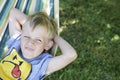 Little child blond boy swinging and relaxing on a hammock Royalty Free Stock Photo