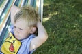 Little child blond boy swinging and relaxing on a hammock Royalty Free Stock Photo