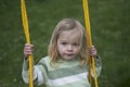 Little child blond girl having fun on a swing outdoor Royalty Free Stock Photo