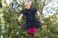 Little child blond girl having fun on a swing outdoor. Royalty Free Stock Photo