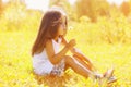 Little child blowing dandelion in sunny summer day Royalty Free Stock Photo