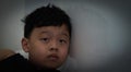 Little child boy Asia head to wall with sad upset fail bored facial expression concept Royalty Free Stock Photo