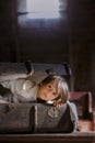 Little child, boy, hiding in old vintage suitcase in the attic