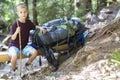 Little child boy with hikers backpack travelling in forest