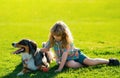 Little child boy with pet dog outdooors in park. Child with pet puppy dog.