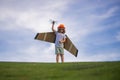 Little child boy is playing and dreaming of flying over the clouds. Pilot aviator child with a toy airplane plays on Royalty Free Stock Photo