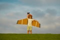 Little child boy is playing and dreaming of flying over the clouds. Child boy toddler playing with toy airplane and Royalty Free Stock Photo