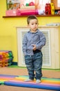 Little child boy playing in kindergarten in Montessori Class. Royalty Free Stock Photo
