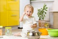 Little child boy playing with kitchenware and foodstuffs in domestic kitchen Royalty Free Stock Photo