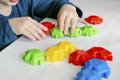 Little child boy playing with mosaic constructor.Babys hands building figures of plastic blocks.Children logic,fine motor skills Royalty Free Stock Photo