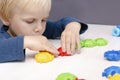 Little child boy playing with mosaic constructor.Babys hands building figures of plastic blocks.Children logic,fine motor skills Royalty Free Stock Photo