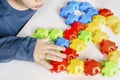 Little child boy playing with mosaic constructor.Babys hands building figures of plastic blocks.Children logic,fine motor skills Royalty Free Stock Photo