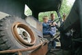 Little child boy playing in old vintage car with his father. Slow life in countryside. Childhood concept. Dad and son together Royalty Free Stock Photo