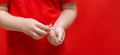 Little child boy pours pills from the can into the hand,healthy concept. It is dangerous tablets in babies hands red background