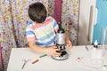 Little child caucasian boy looking through microscope in school Royalty Free Stock Photo