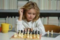 Little child chessman play chess game, checkmate.