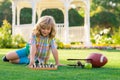 Little kid chessman play chess game, checkmate. Child playing chess in spring park. Kid playing chess and having fun