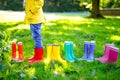Little child in colorful rain boots. Close-up of school or preschool legs of kid boy or girl in different rubber boots Royalty Free Stock Photo