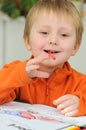 Little child with crayon in mouth