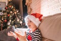 Little child and decorated Christmas tree, portrait. Royalty Free Stock Photo