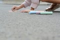 Little child drawing butterfly and hearts with chalk on asphalt, closeup. Space for text Royalty Free Stock Photo