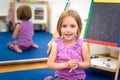 Little child is drawing with color chalk on the chalk board Royalty Free Stock Photo