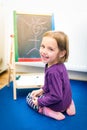 Little child is drawing with color chalk on the chalk board Royalty Free Stock Photo