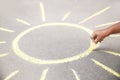 Little child drawing sun with chalk on asphalt Royalty Free Stock Photo