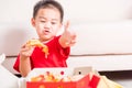 Little Child eating Delivery Pizza and show good finger thumb Royalty Free Stock Photo