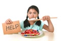 Little child eating sweet sugar in candy dish holding sugar spoo Royalty Free Stock Photo