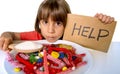 Little child eating sweet sugar in candy dish holding sugar spoo Royalty Free Stock Photo