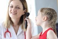 Little child examining doctor ear with otoscope in clinic Royalty Free Stock Photo