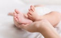 Little baby feet in mother hands closeup Royalty Free Stock Photo