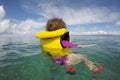 Little child floating with a life jacket alone in the ocean Royalty Free Stock Photo