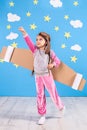 Little child girl in an astronaut costume is playing and dreaming of becoming a spaceman. Royalty Free Stock Photo