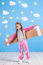 Little child girl in an astronaut costume is playing and dreaming of becoming a spaceman. Royalty Free Stock Photo