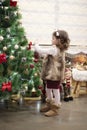Little child girl decorating Christmas tree with balls at home, indoors. Close up. Christmas concept Royalty Free Stock Photo