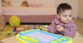 little child girl drawing on magnetic erasable board