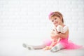 Little child girl dreams of becoming ballerina with ballet shoe