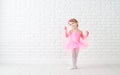 Little child girl dreams of becoming ballerina