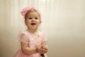 little child girl in elegant pink dress with bow on head on birthday celebration Royalty Free Stock Photo