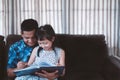 Little child girl and father are enjoying reading book together at home.Social distance during quarantine, Online education Royalty Free Stock Photo