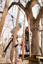 Little girl fears climb in rope Park in the spring Royalty Free Stock Photo