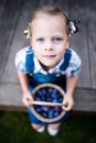 Little child girl gardener with basket full of plums