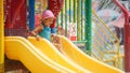 Little child girl having fun on water slides on  summer vacation in aqua park with smile and happy Royalty Free Stock Photo